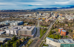 Aerial photo with artist rendering of multi-story buildings for the Lusk District Redevelopment project